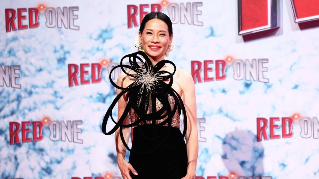 Lucy Liu attends the premiere of "Red One - Alarmstufe Weihnachten!" at UCI Luxe Mercedes Platz in a sculptural Zuhair Murad gown on November 03, 2024 in Berlin, Germany.