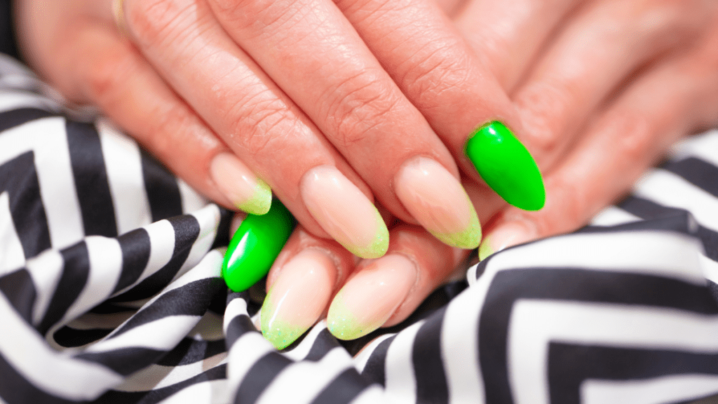 Close up of Fake Nails, Acrylic Nails, Gel nails on a woman's hand in neon colours